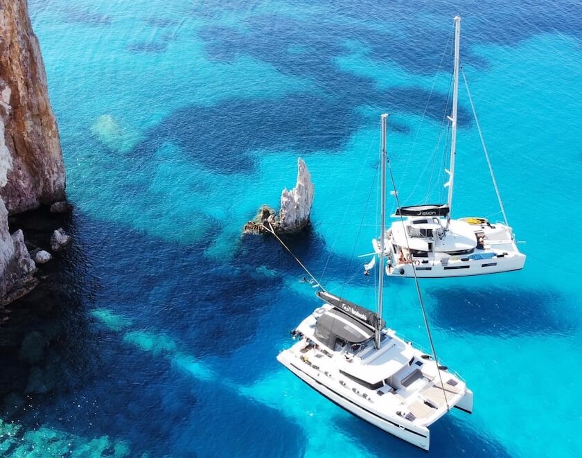 Catamarans at anchor in the translucent waters of Polyaigos
